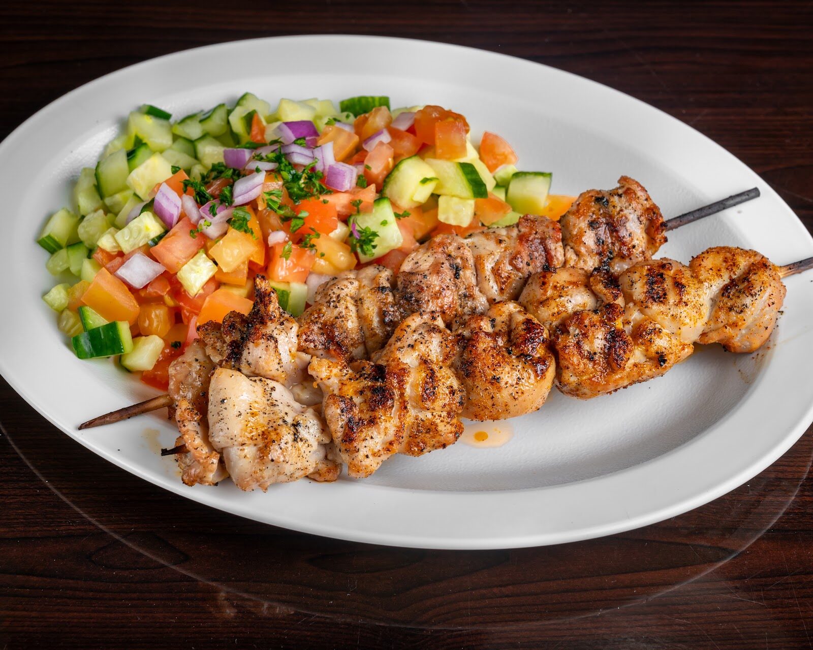 Grilled chicken skewers with Israeli salad